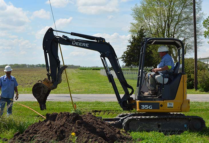 mini trackhoe moving dirt