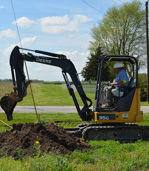 mini trackhoe moving dirt